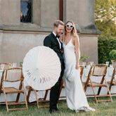 Couple with a Paper Umbrella at the wedding party
