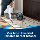 User deep cleaning a living room carpet with the Green Pro Portable Cleaner