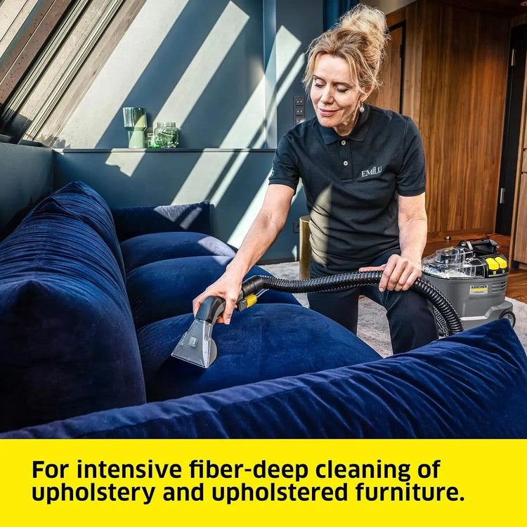 Homeowner removing pet stains from living room carpet with spot cleaner